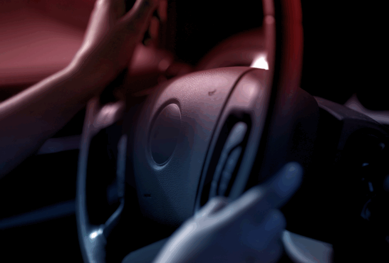 Image is of hands on a driving wheel in a car, concept of what to do if you get arrested for DUI in Jacksonville on 4th of July