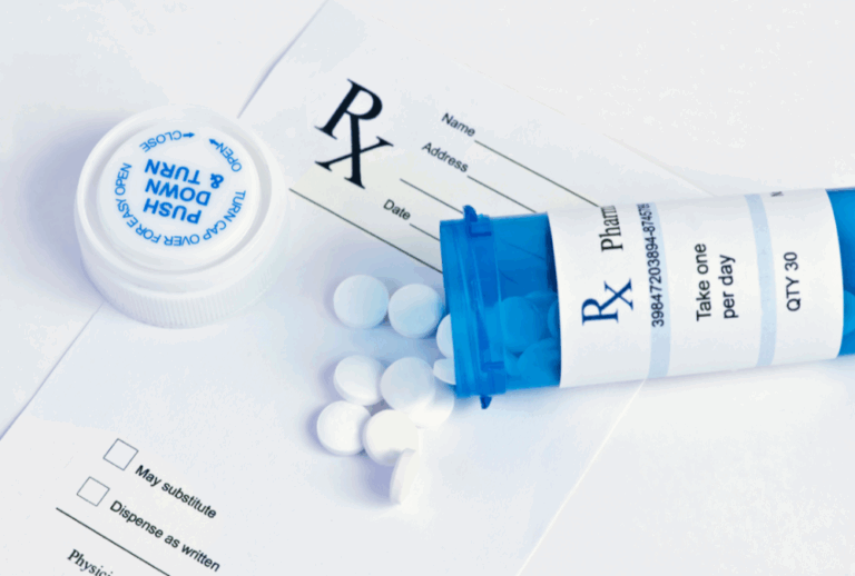 Image is of a prescription drug bottle spilled and a prescription paper, concept of DUI for