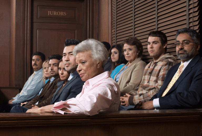 Image is of a jury in the jury box in a courtroom, concept of representing yourself in a criminal case