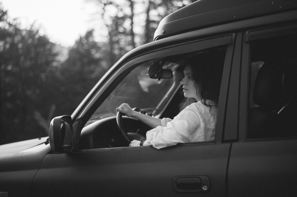Woman siting in her car calmly.