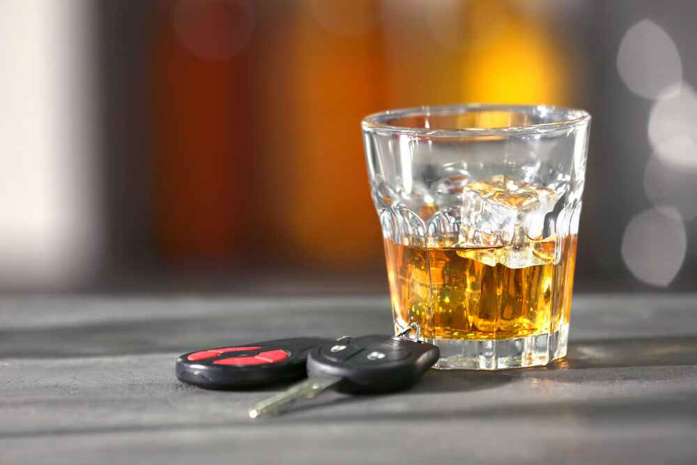 Glass of alcohol on table representing DUI consequences in Florida