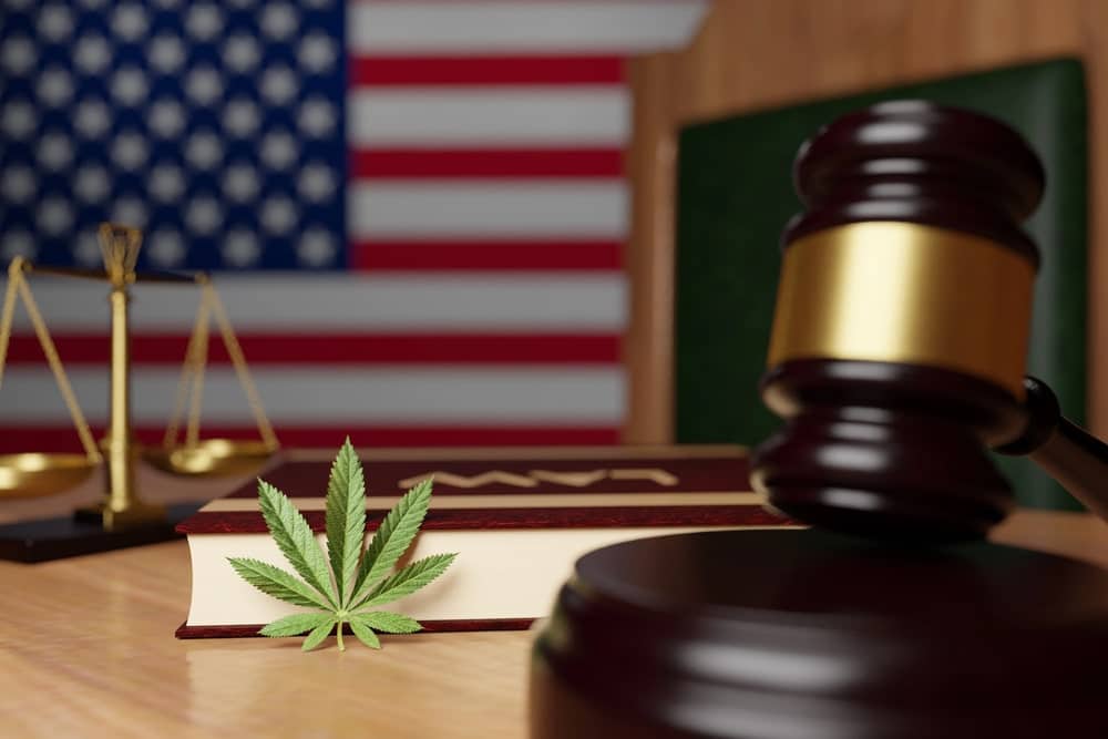 Judge’s gavel, law book, and marijuana leaf with American flag symbolizing marijuana possession penalties in Florida.