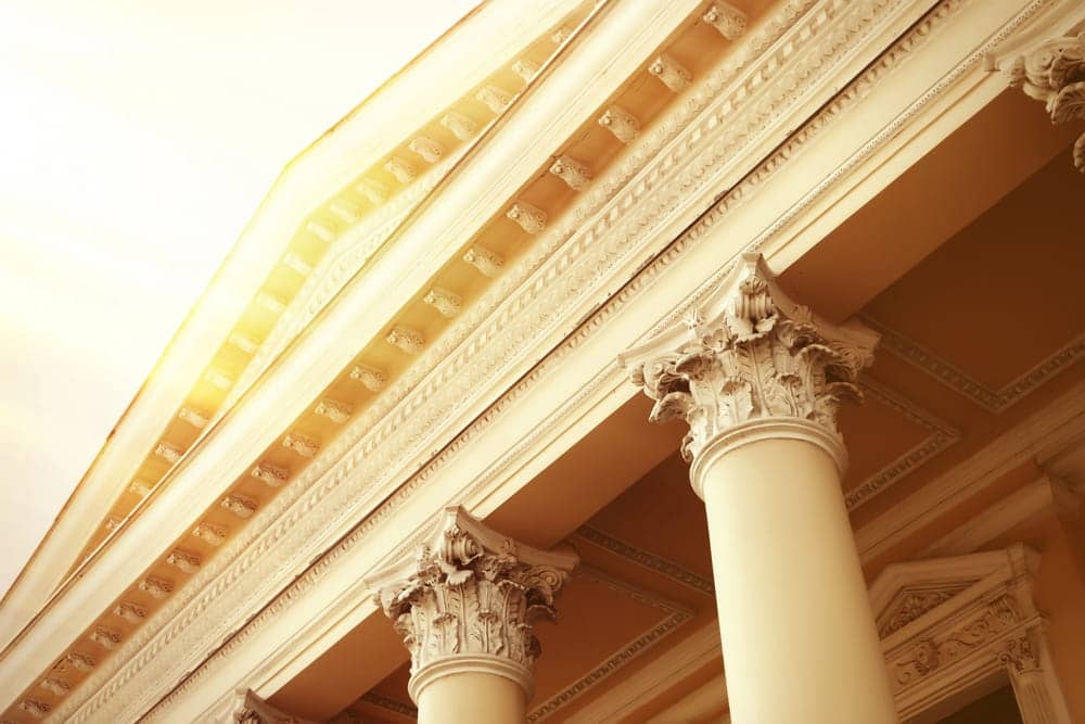 Image is of courthouse columns viewed from below, concept of DUI cases and legal consequences for Florida professional licenses.
