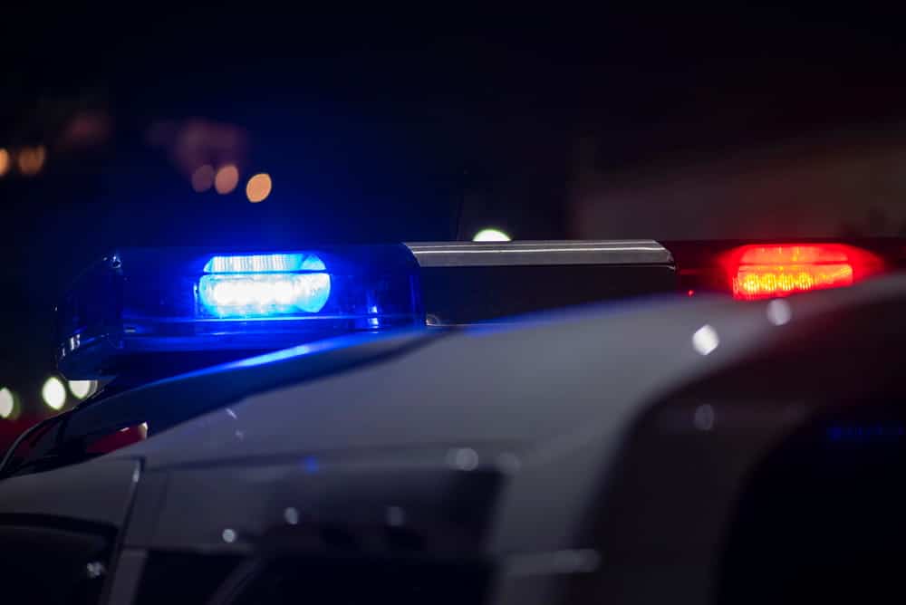 Image is of police lights flashing during a nighttime traffic stop, concept of a DUI case beginning in Ponte Vedra Beach