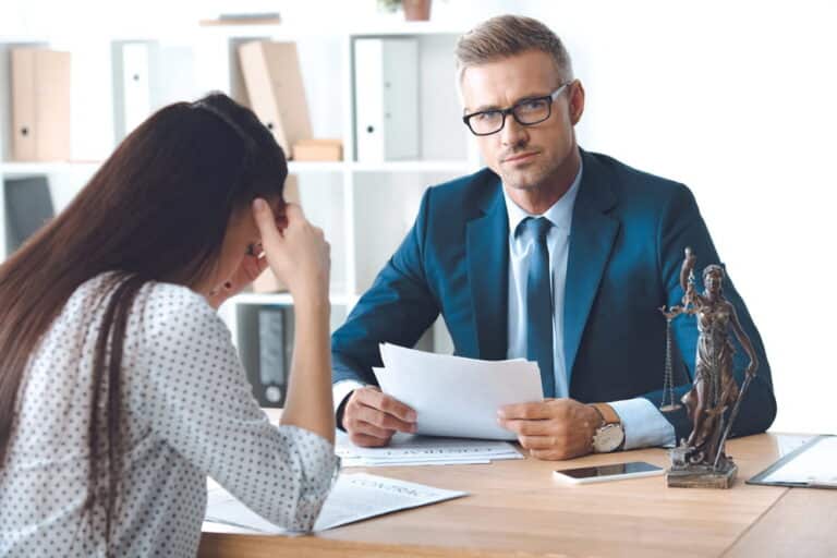 Image is of a lawyer discussing documents with a client, concept of DV case in Ponte Vedra Beach legal consultation