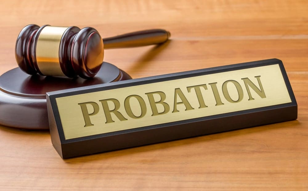 Image is of a probation nameplate and gavel on a desk, concept of DV case in Ponte Vedra Beach legal conditions