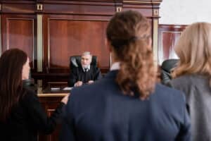 Image is of a courtroom hearing with a judge addressing participants, showing drug court in Ponte Vedra Beach proceedings
