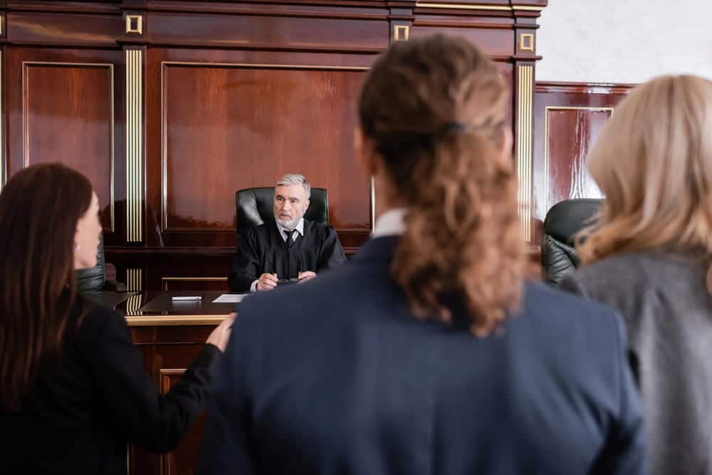 Image is of a courtroom hearing with a judge addressing participants, showing drug court in Ponte Vedra Beach proceedings