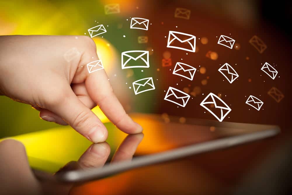 Image is of digital message icons appearing above a tablet screen, concept of electronic communication and stored conversations examined in DV cases.