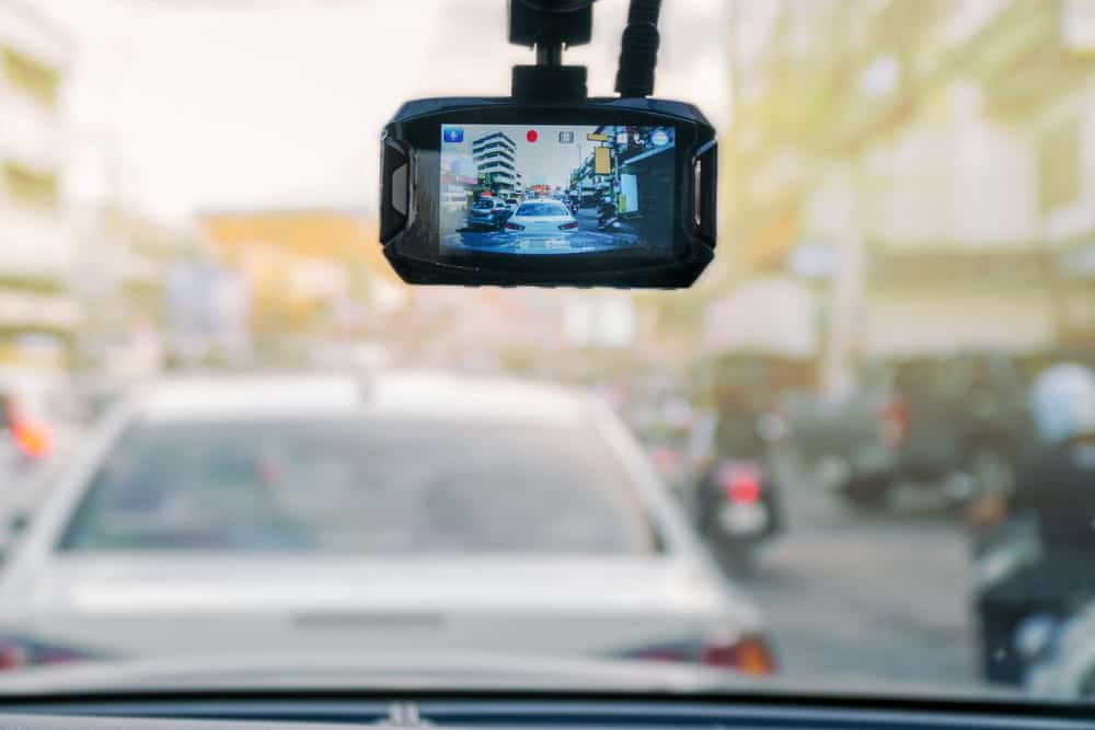 Image is of a dashboard camera recording traffic conditions on a public roadway, concept of evidence that may be reviewed when challenging a DUI charge.