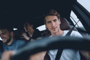 Image is of a driver and passengers traveling together, concept of determining responsibility during a drug arrest in a shared vehicle.