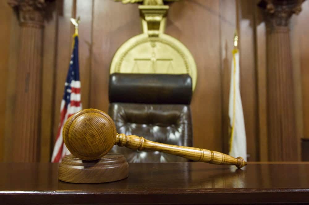 Image is of a courtroom bench and gavel where matters involving a DV bond hearing may be addressed by the court.