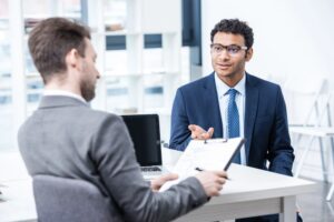 Image is of a job applicant speaking with an interviewer, concept of how a DUI affect your job during the hiring process.