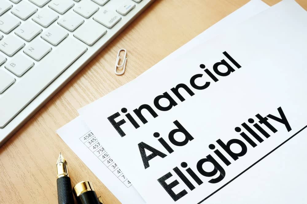 Image is of financial aid eligibility paperwork on a desk, concept of eligibility questions after drug charges