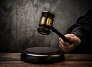 Image is of a judge holding a wooden gavel above a sound block, representing the legal consequences of drug charges without possession in Ponte Vedra Beach.