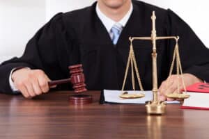 Image shows a judge holding a wooden gavel beside the scales of justice, representing how courts determine DUI sentencing in Ponte Vedra Beach.