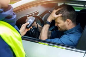 Image is of a driver undergoing a breath test during a traffic stop, concept of breath test in Ponte Vedra Beach