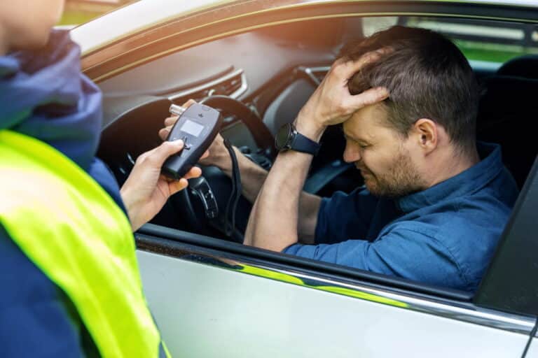 Image is of a driver undergoing a breath test during a traffic stop, concept of breath test in Ponte Vedra Beach